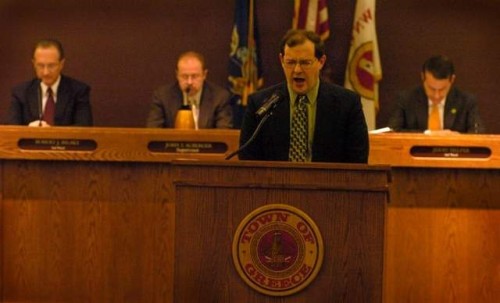 Rev. Kevin Kisler prays prior to the start of a Greece, N.Y., Town Board meeting in 2008. Photo: Rochester Democrat and Chronicle