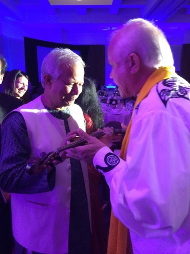 Muhummed Yunus blessing World Peace Violin [Courtesy of the Patrick McCollum Foundation]