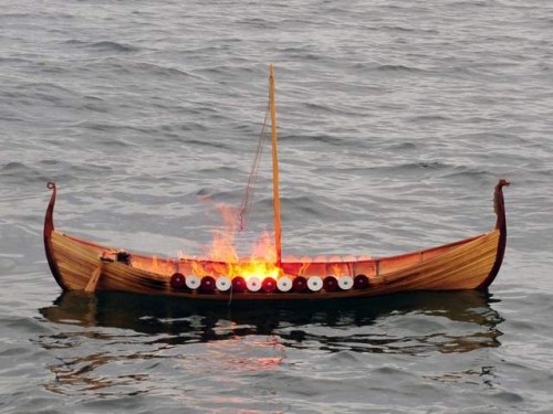 A handmade wooden boat containing Haines' ashes burns during a burial at sea Sept. 29. [Petty Officer 2nd Class Cynthia Oldham / USCG]