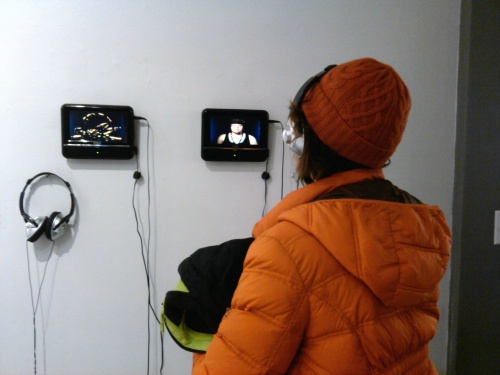 A non-Pagan attendee takes in a video art installation piece [c schulz]