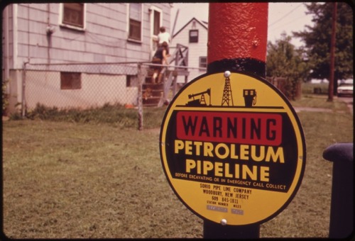 Pipeline warning sign in a residential neighborhood in Woodbridge, NJ, circa 1974. Photo by Ike Vern.