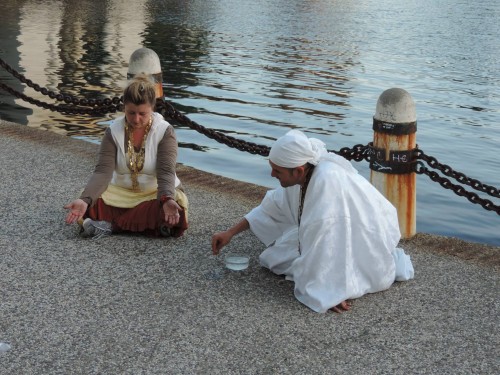 Florez with friend Yeshe Rabbit pouring libation and honoring the sweet waters at Lake Merritt [Courtesy Photo]