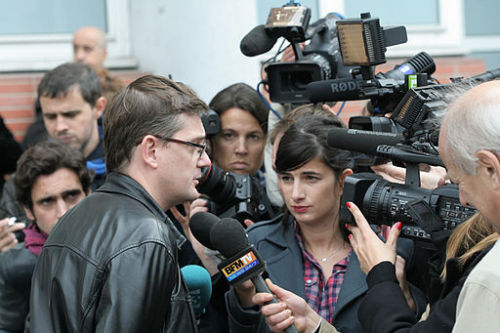 Charlie Hebdo's Editor talks to media after 2011 fire bombing [Photo Credit: Coyau / Wikimedia]