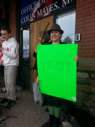 Sable Aradia protesting Bill C-51 outside the office of her local Member of Parliament. [Photo by Chris Madsen]