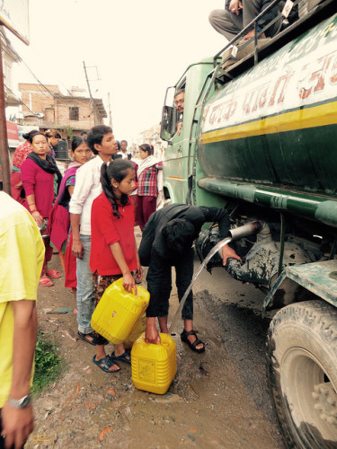 People line up for clean water. [Photo Credit: Walter Lines / Flickr]