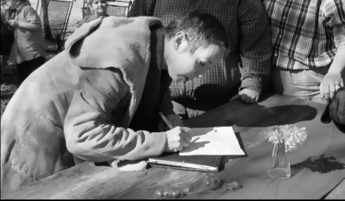 Priestess signing legal documentation for a same-sex married couple in Alabama [Courtesy K. Privett-Duren]