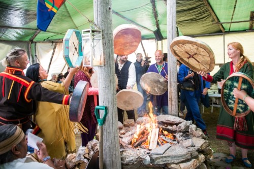 Shamans hold their drums over the Holy Fire in order to warm them and obtain a clearer sound whiel drumming.