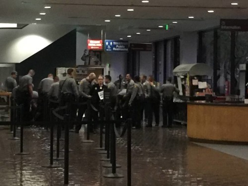 Police arrest T. Thorn Coyle (center) and other faith leaders. 