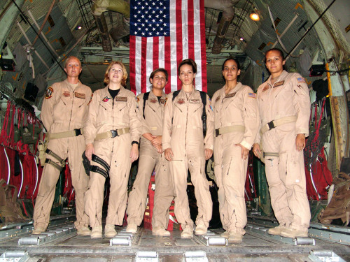 SOUTHWEST ASIA -- From left to right, Staff Sgt. Josie E. Harshe, flight engineer; Capt. Anita T. Mack, navigator; 1st Lt. Siobhan Couturier, pilot; Capt. Carol J. Mitchell, aircraft commander; and loadmasters Tech. Sgt. Sigrid M. Carrero-Perez and Senior Airman Ci Ci Alonzo, pause in the cargo bay of their C-130 for a group photo following their historic flight. (U.S. Air Force photo)