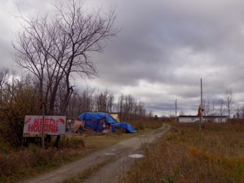 Kakikepinace's camp, with mold-infested trailer in background (photo by Dodie McKay)