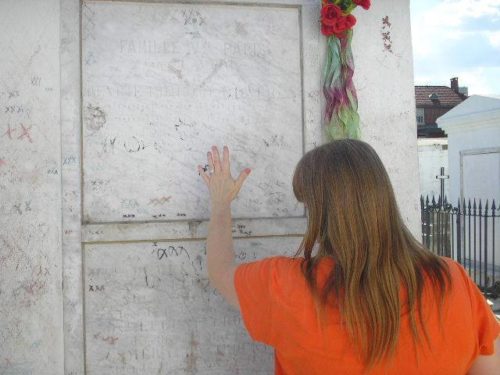 Velvet praying at Marie Laveau's tomb in St. Louis Cemetery No. 1