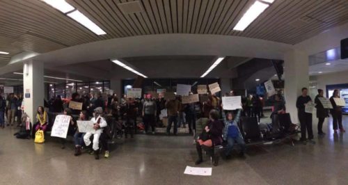 Elysia Gallo (far left) at Minneapolis Airport protest [Photo Credit: Laura Eash]