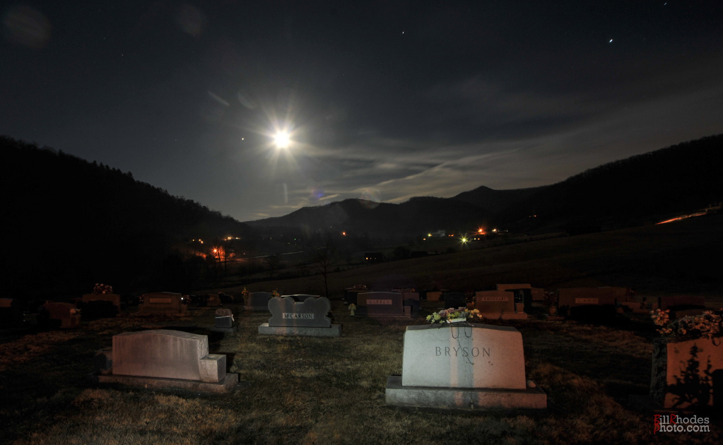 The moon rises over a cemetery [B. Rhodes